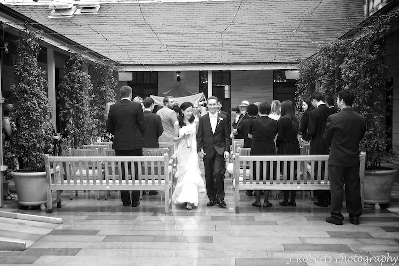 bride and groom walking down the aisle - wedding photography sydney